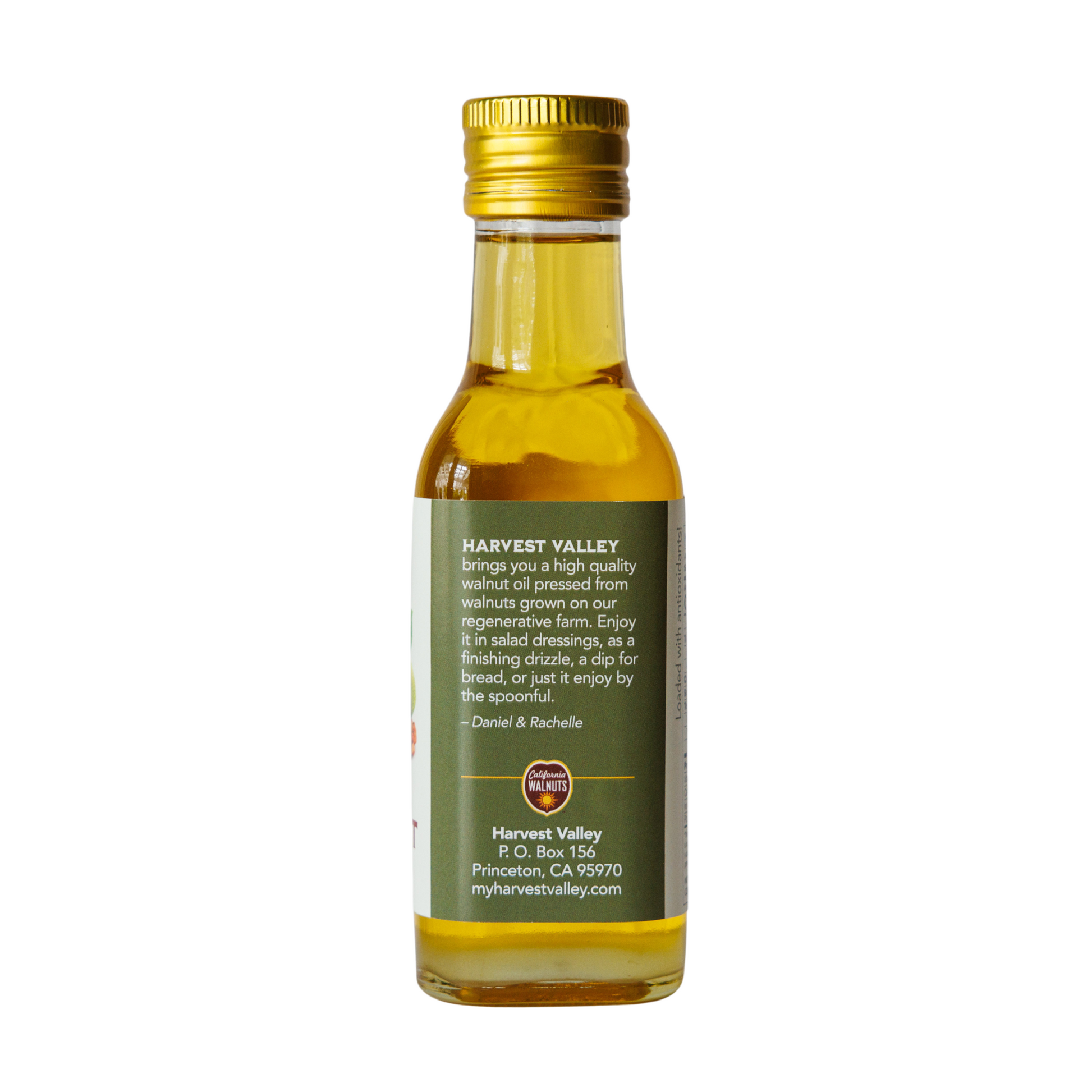 Side of walnut oil bottle from Harvest Valley with company and contact info.