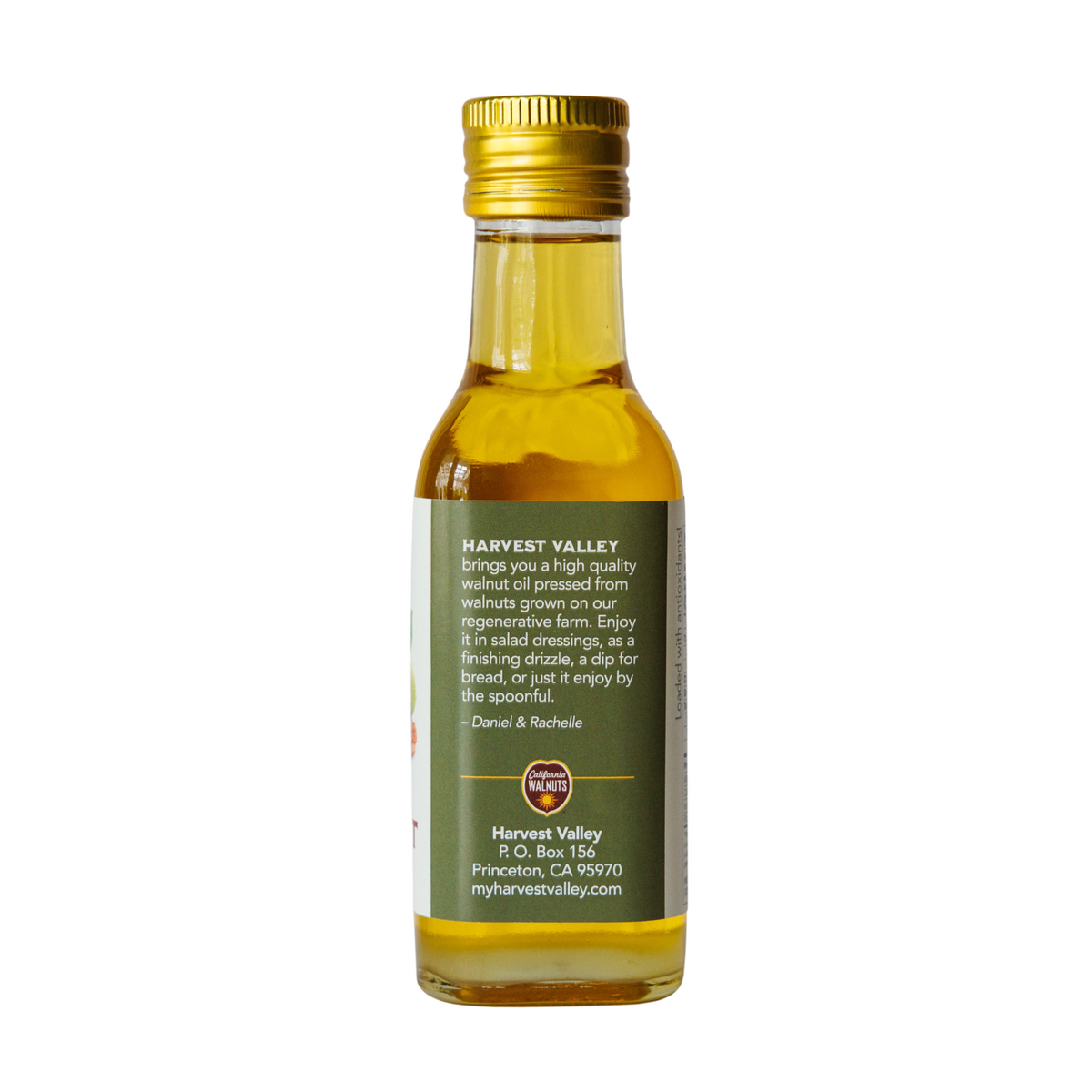 Side of walnut oil bottle from Harvest Valley with company and contact info.
